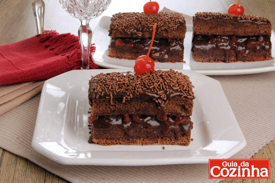 Aprenda como fazer esta receita maravilhosa de bolo de brigadeiro gelado decorado com chocolate granulado e cereja! É irresistível!