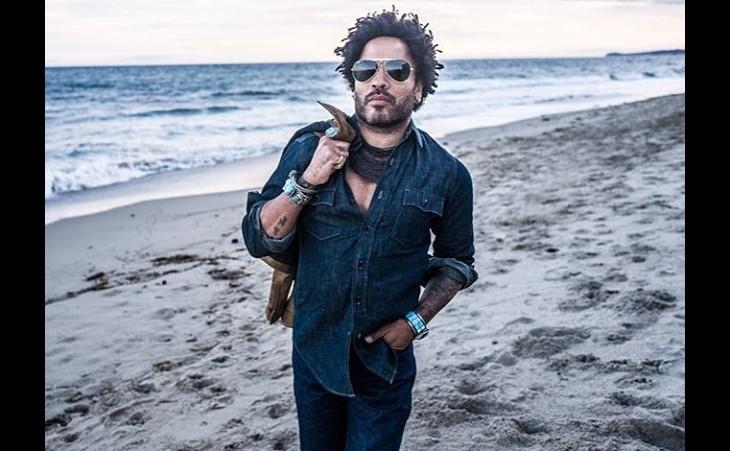 Fotografia do cantor Lenny kravitz caminhando em uma praia