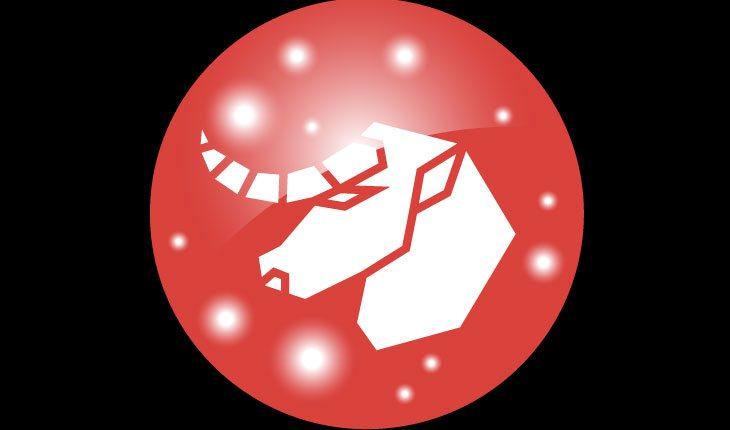 Na foto há o símbolo do signo de Touro (um touro) em branco em um fundo vermelho em formato circular.