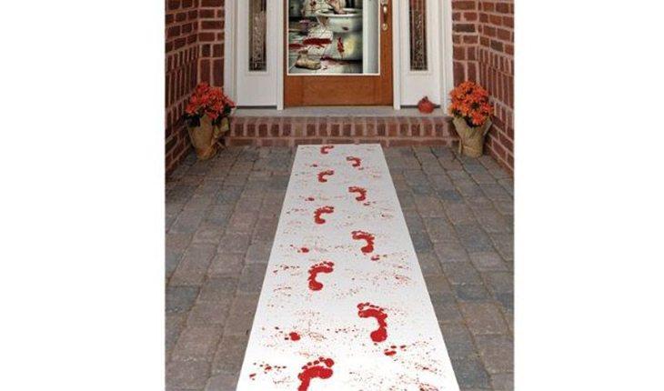Na foto há uma ideia de decoração de Halloween com uma entrada com um caminho de sangue desenhado