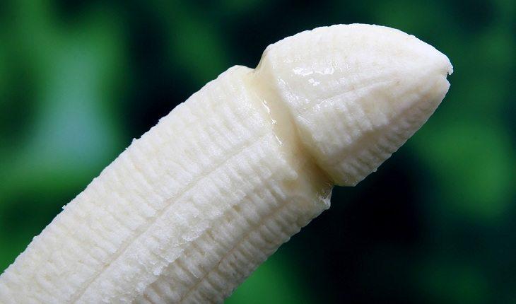 Na imagem, uma banana está sem casca e com formato de pênis. Eficácia da camisinha.
