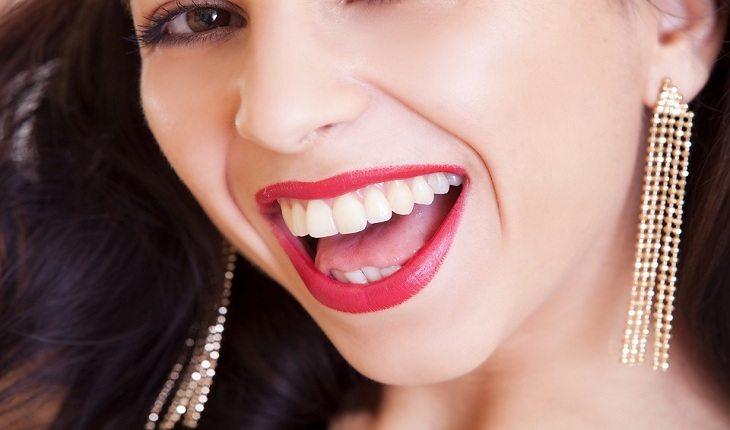 foto aproximada da boca de uma mulher rindo