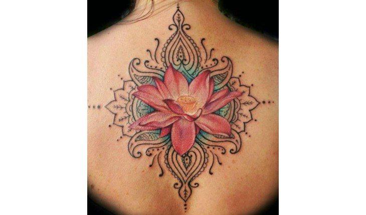Costas tatuada com flor colorida.
